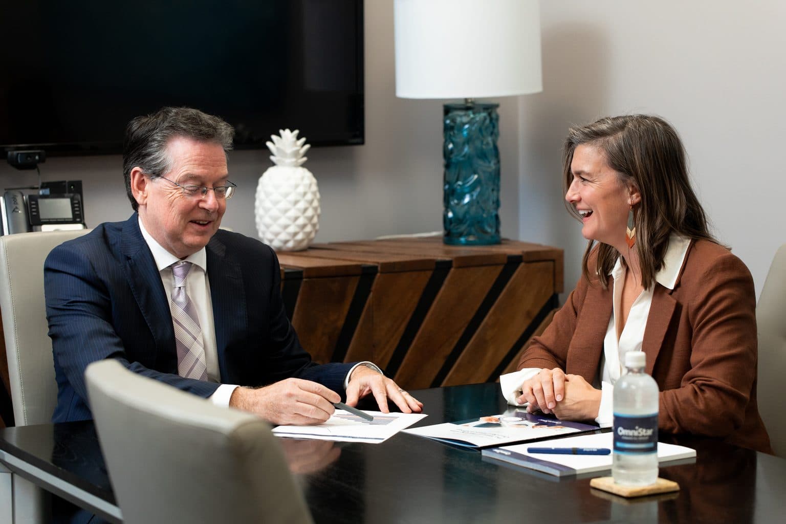 An OmniStar advisor and a client reviewing a plan together