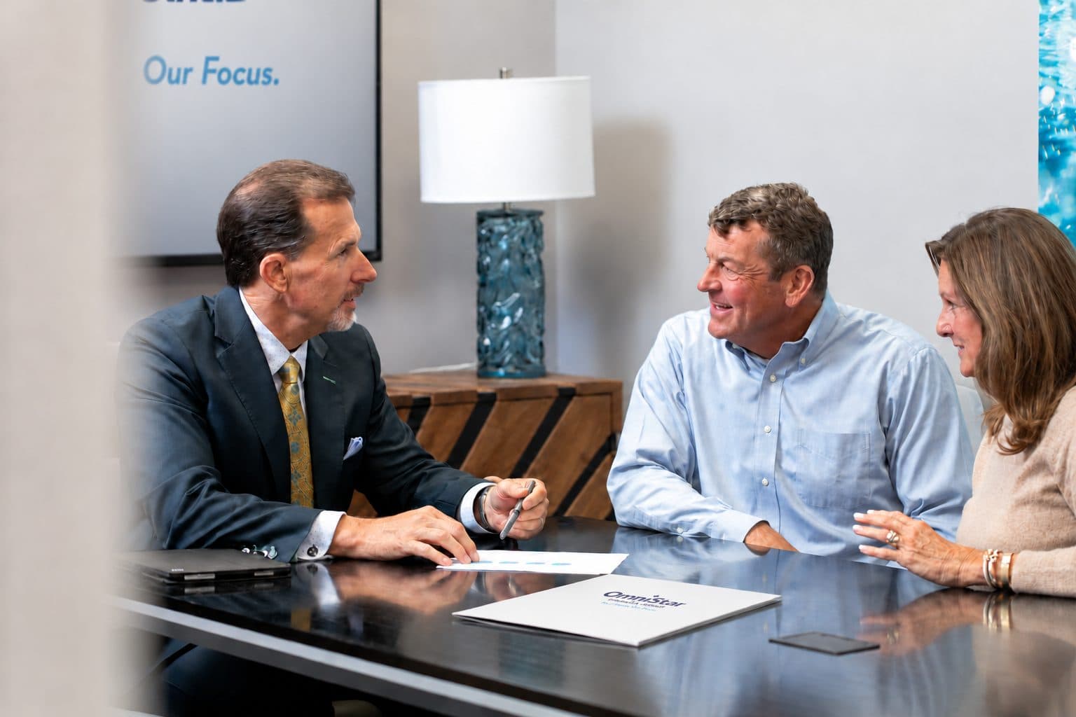 A couple meeting with their OmniStar advisor at the office
